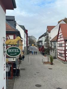 a street with a hotel sign in a town at Hotel Goldenes Lamm in Idstein