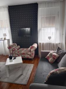 a living room with a couch and a table at Apartman 51 in Vračar (historical) +7 photos