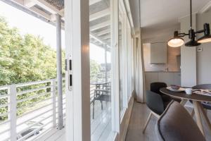 a room with a balcony with a table and chairs at Hello Zeeland - Appartement Beatrixstraat 29 in Domburg