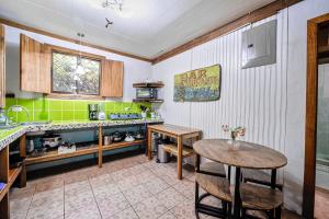 a kitchen with a table and some green at Azania Oasis in Puerto Viejo