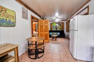 a kitchen with a refrigerator and a table at Azania Oasis in Puerto Viejo