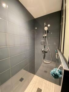 a bathroom with a shower with a glass door at Ty Matelot by Póm - Proche centre-ville in Lorient
