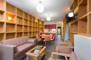 a living room with a couch and a table at Les Woodies in Xertigny