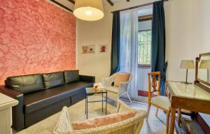 una sala de estar con un sofá de cuero negro y sillas en La Ferriera Villa da Sogno, en Castel Focognano