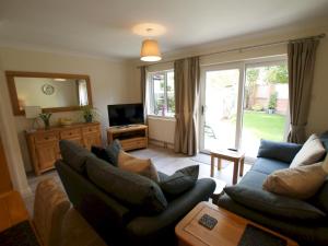 a living room with two couches and a television at Pass the Keys Homely and central with parking in Exeter