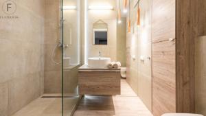 a bathroom with a sink and a glass shower at Flatbook - City Center SPA Apartments Toruńska in Gdańsk