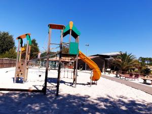 a playground with a slide in a park at Charmant mobil home 331 camping 4* Siblu La Réserve in Gastes