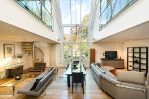 a large living room with a couch and a table at Unique 2 Bedroom converted Artists Studio in London