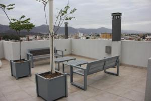 a group of benches sitting on top of a roof at HAUS APARTAMENTOS in Salta