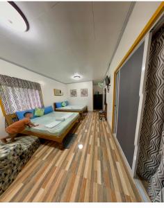 a room with a bed and a couch in it at Domos Native Guest House in Panglao