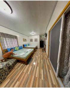 a room with a bed and a couch in it at Domos Native Guest House in Panglao Island