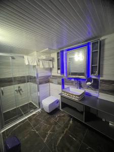 a bathroom with a sink and a shower at Ünaten otel in Gaziemir