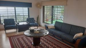 a living room with a couch and a table at LEVEL FIVE ZERO in Murree