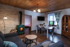 a living room with a couch and a table with a fireplace at Chaty Ski Telgárt in Telgárt