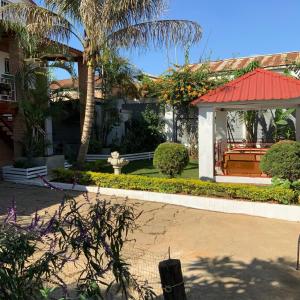 a house with a red roof and a garden at Villa Eden Wood in Ivato