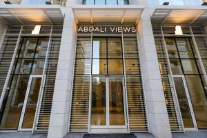 a building with glass doors with the words abral views at Abdali Views Apartments in Amman