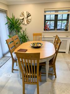 a dining room table with chairs and a bowl on it at Old Manse Cottage in Durness