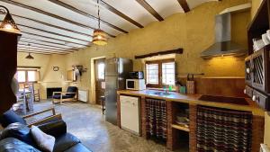 een keuken met een koelkast en een aanrecht bij 8 bedrooms villa with private pool furnished garden and wifi at Taberno in Taberno
