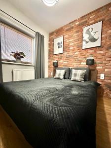 Posteľ alebo postele v izbe v ubytovaní LuxApart Kalisz Loft