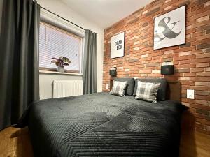 Posteľ alebo postele v izbe v ubytovaní LuxApart Kalisz Loft