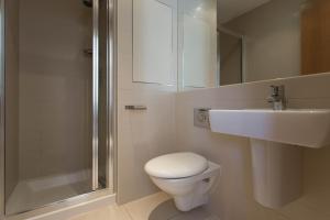 uma casa de banho com um WC, um lavatório e um chuveiro em Concept Serviced Apartments by Concept Apartments em Londres