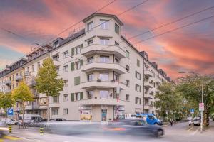 a building on a street with cars in front of it at one bedroom apartment in trendy Zurich West in Zurich