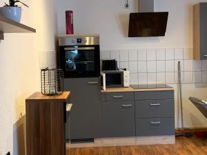 a kitchen with a refrigerator and a microwave at Ferienwohnung Am Markt in Annaberg-Buchholz