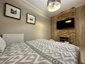 Posteľ alebo postele v izbe v ubytovaní LuxApart Kalisz Loft