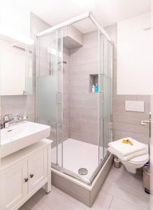 a bathroom with a shower and a toilet and a sink at one bedroom apartment in trendy Zurich West in Zürich +3 photos