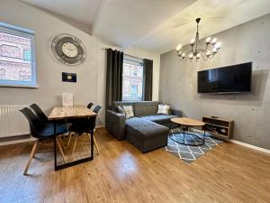 Televízia a/alebo spoločenská miestnosť v ubytovaní LuxApart Kalisz Loft