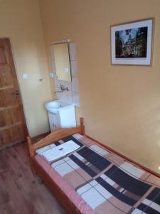 a bedroom with a bed and a sink and a mirror at Motel Sportowy OSiR Jawor in Jawor +43 photos