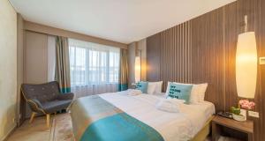 Postel nebo postele na pokoji v ubytování SeePark Hotel Murten