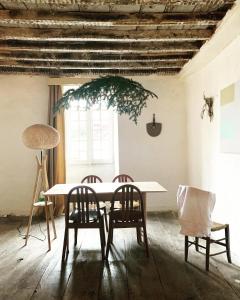 a dining room with a table and two chairs at Aburry, maison poétique à la montagne in Barcus +68 photos