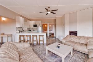 a living room with a couch and a table at Amblewood Beach Cottages in Kenton on Sea