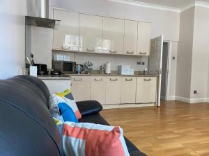 a living room with a couch and a kitchen at Sight Flats - SF01 - One Bedroom in London