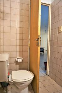 a bathroom with a toilet and a door open at Alem PA4 Mendoza in Mendoza