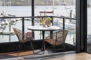 a table and chairs on a balcony with a marina at The Other 43 in Kinsale