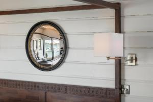 a mirror on a wall next to a lamp at The Other 43 in Kinsale