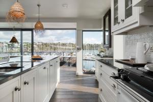 a kitchen with white cabinets and a view of the water at The Other 43 in Kinsale