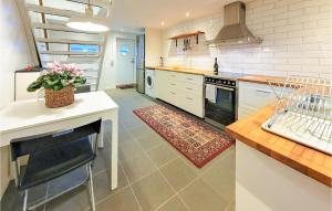 a kitchen with white cabinets and a stove top oven at Gorgeous Home In Rydebck With Wifi in Rydebäck