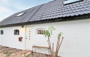 a white house with a bench in front of it at Gorgeous Home In Rydebäck With Wifi in Rydebäck
