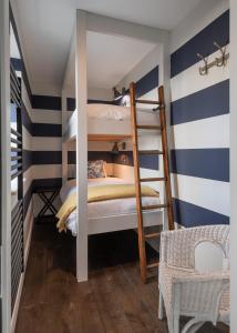 a boys room with two bunk beds and a chair at The Other 43 in Kinsale