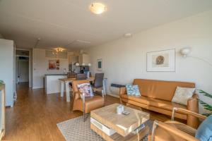 a living room with a couch and a table at Appartementencomplex Juliana 52 in De Koog