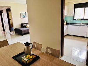 una cocina y una mesa con un hervidor de agua. en Spacious 3 Bedroom Apartment Excellent Location Bugolobi Kampala - Immersion 1 en Kampala