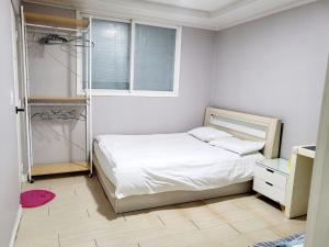 a small bedroom with a bed and a window at Daegu Gyeong`s Hostel - Foreigner Only in Daegu