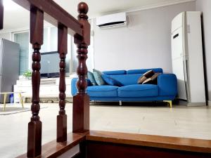 a blue couch in a living room at Daegu Gyeong`s Hostel - Foreigner Only in Daegu