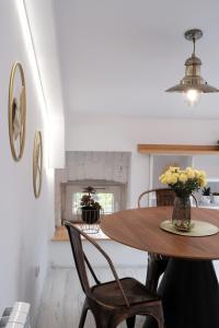 a dining room with a wooden table and chairs at Loft Parkowa in Przemyśl