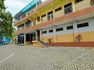 a building with balconies and stairs in a street at Collection O 91914 Hotel Citra Dewi 2 Int's in Semarang