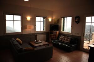 a living room with a couch and a table at Chalet Perinaldo in Perinaldo