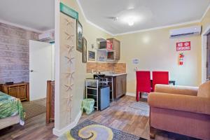 a living room with a couch and a kitchen at Cocoplum Rest N Hideaway #1 in Nassau